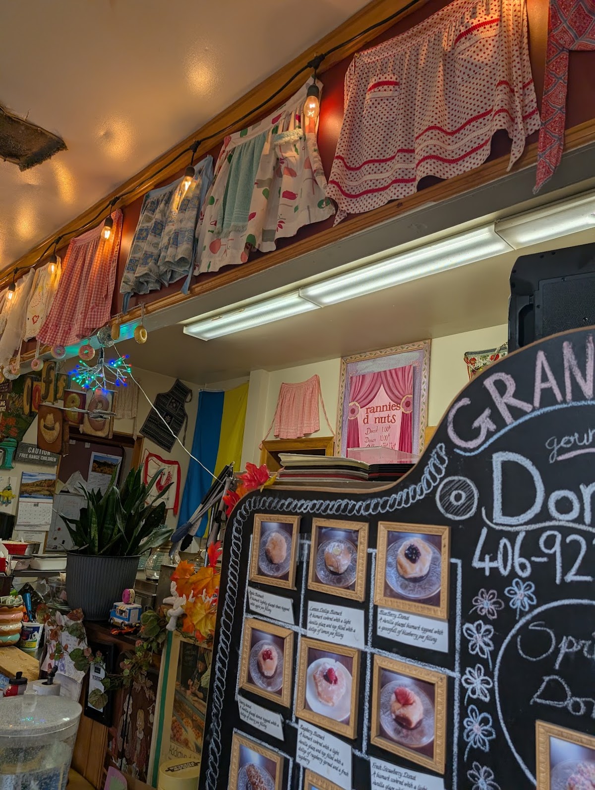 Cozy interior of Granny's with vintage aprons strung up and a chalkboard menu