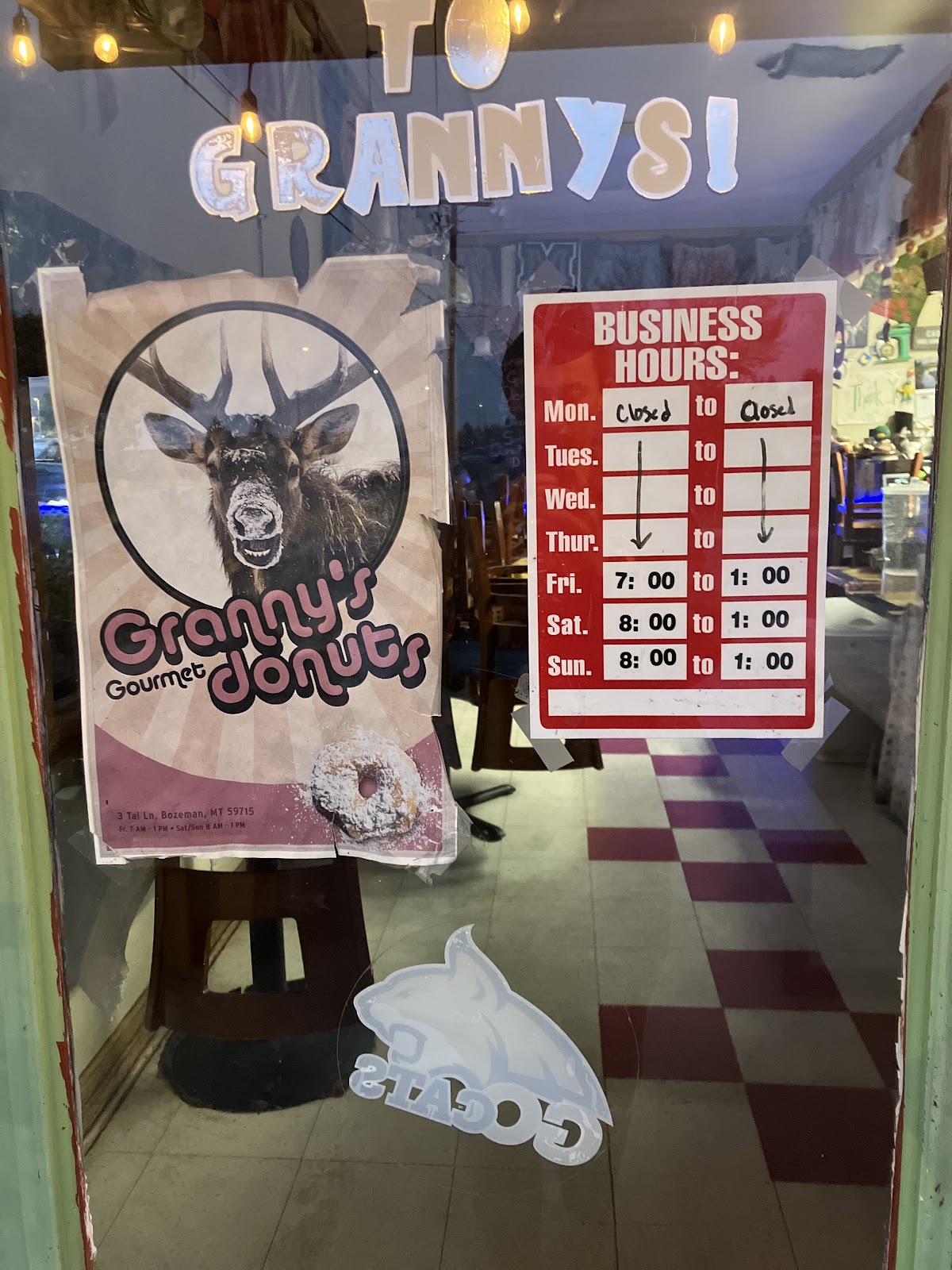 Granny's window with the donut poster and the posted weekend hours