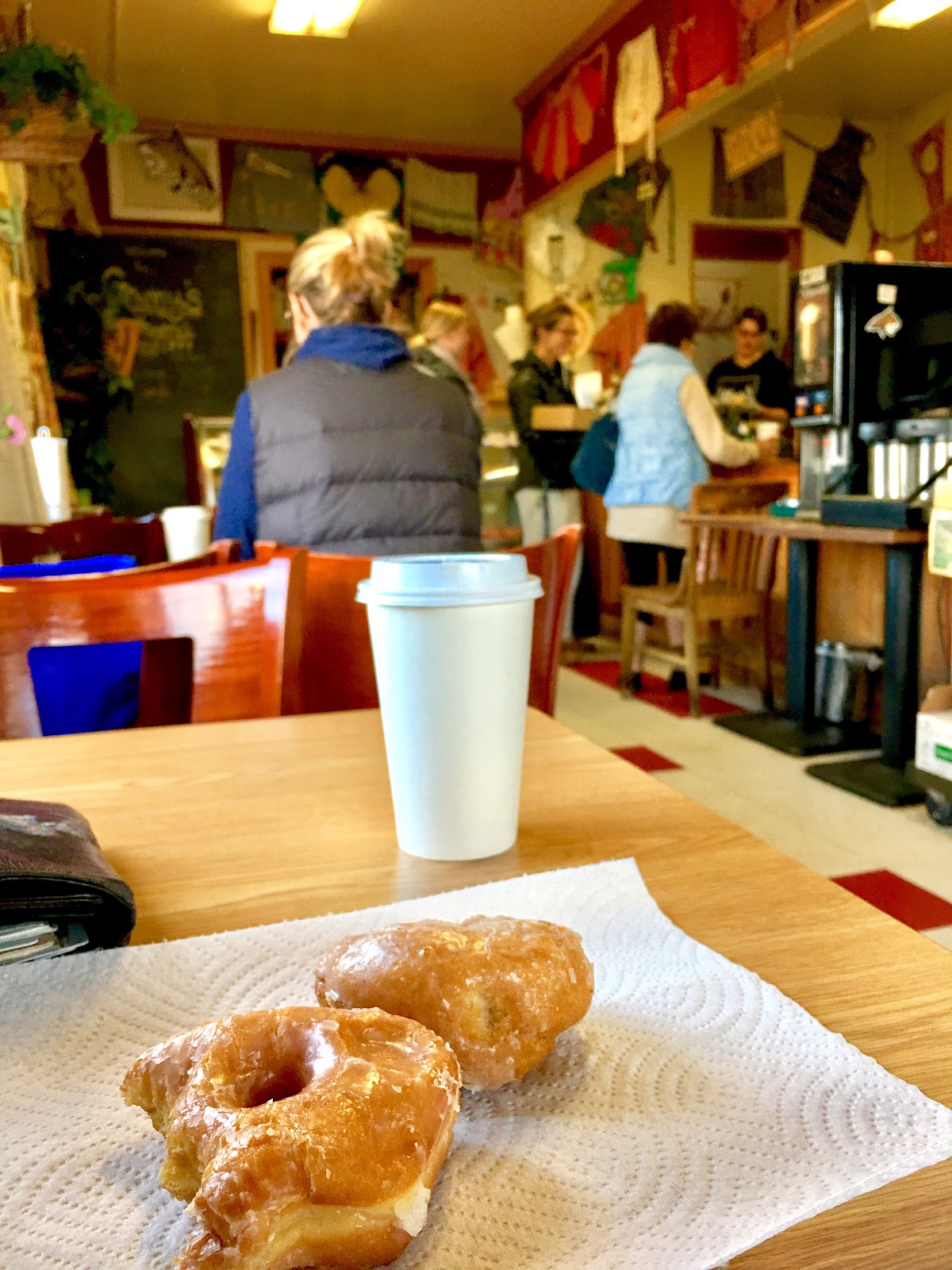 Customers lined up at the counter inside Granny's with coffee and donuts